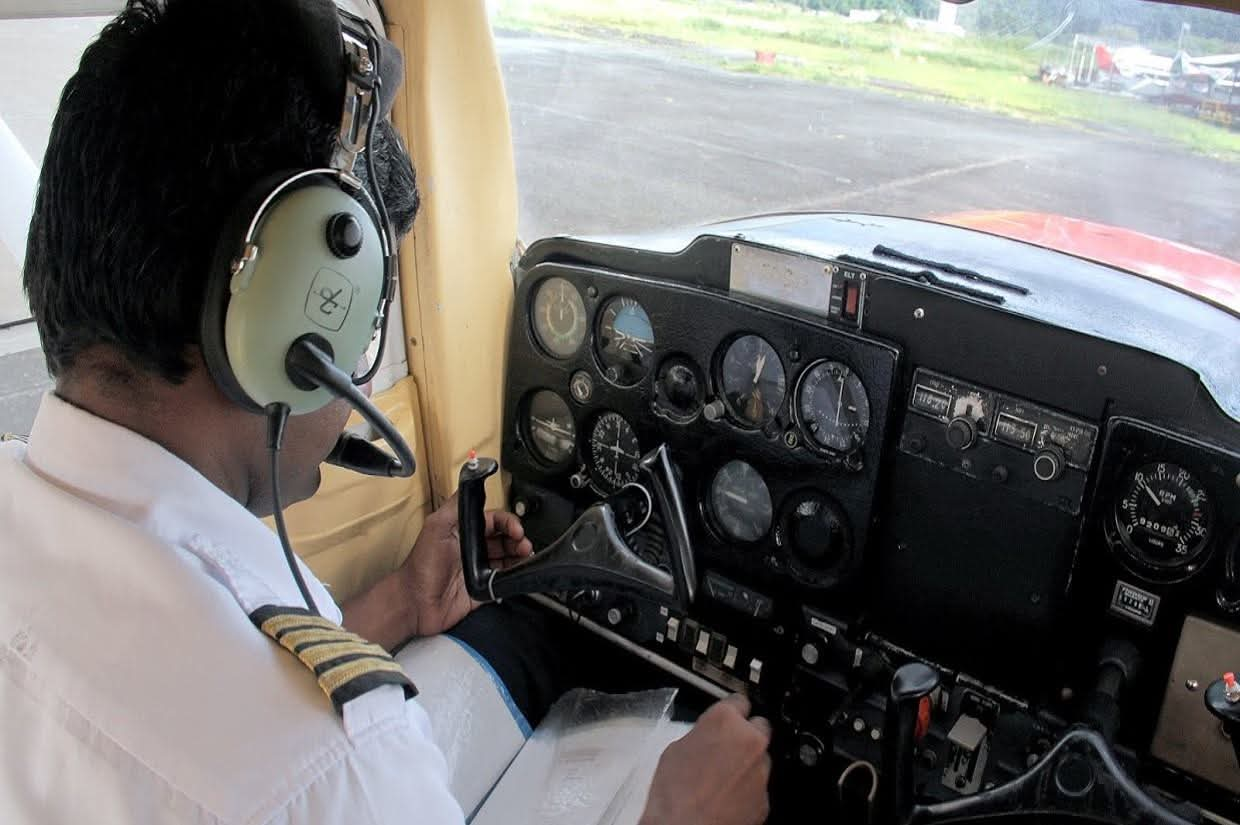 Flight instructor briefing a student in the cockpit