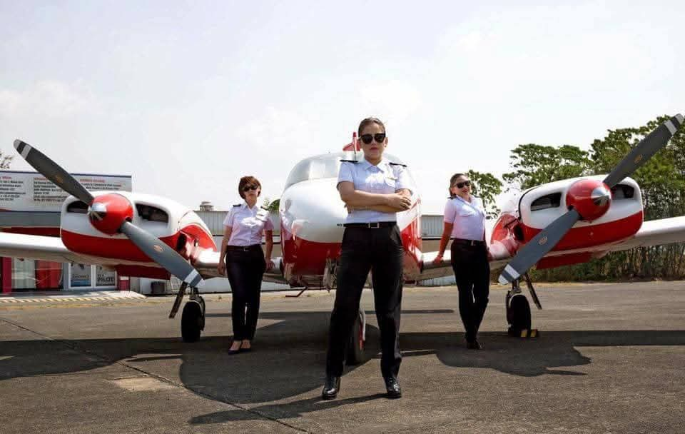 Avestar student pilots standing beside a training aircraft at Subic Bay